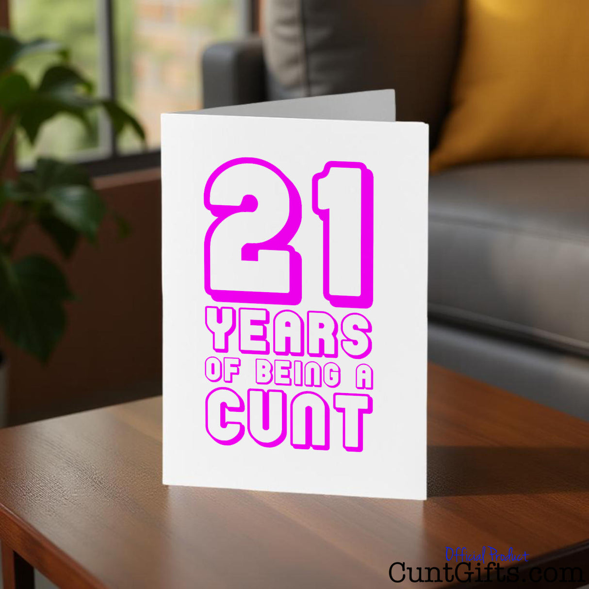 Cunt Card with pink text '21 YEARS OF BEING A CUNT' on a wooden table