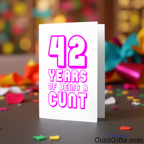 Cunt Card with pink text '42 YEARS OF BEING A CUNT' on a colourful background