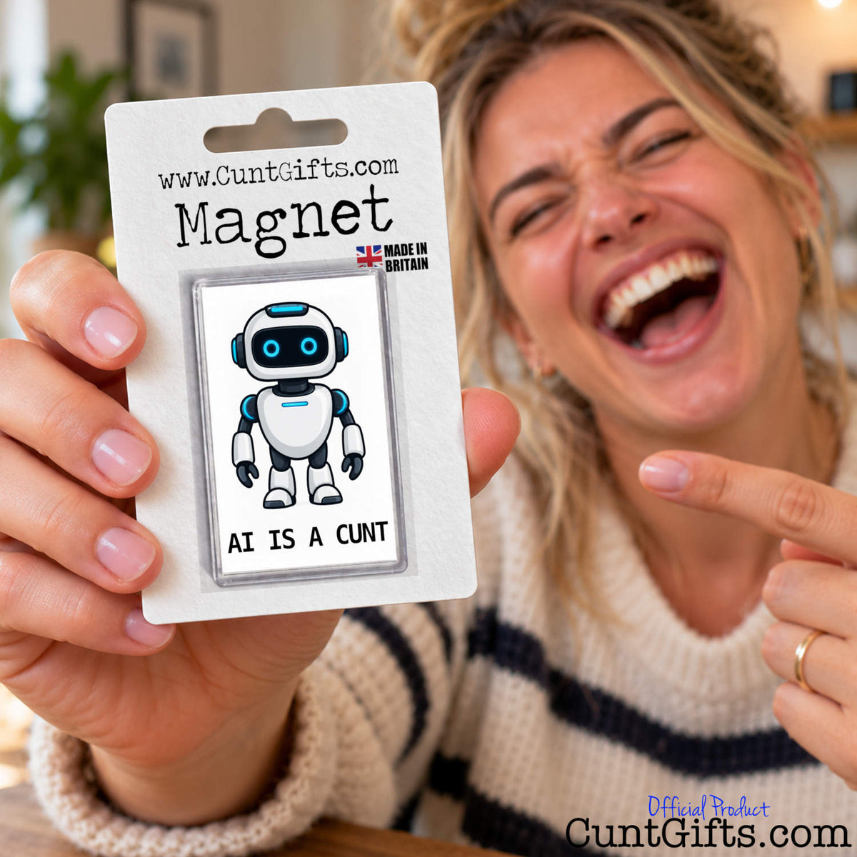Smiling woman holding up a packaged AI Is a Cunt novelty fridge magnet featuring a cartoon robot.