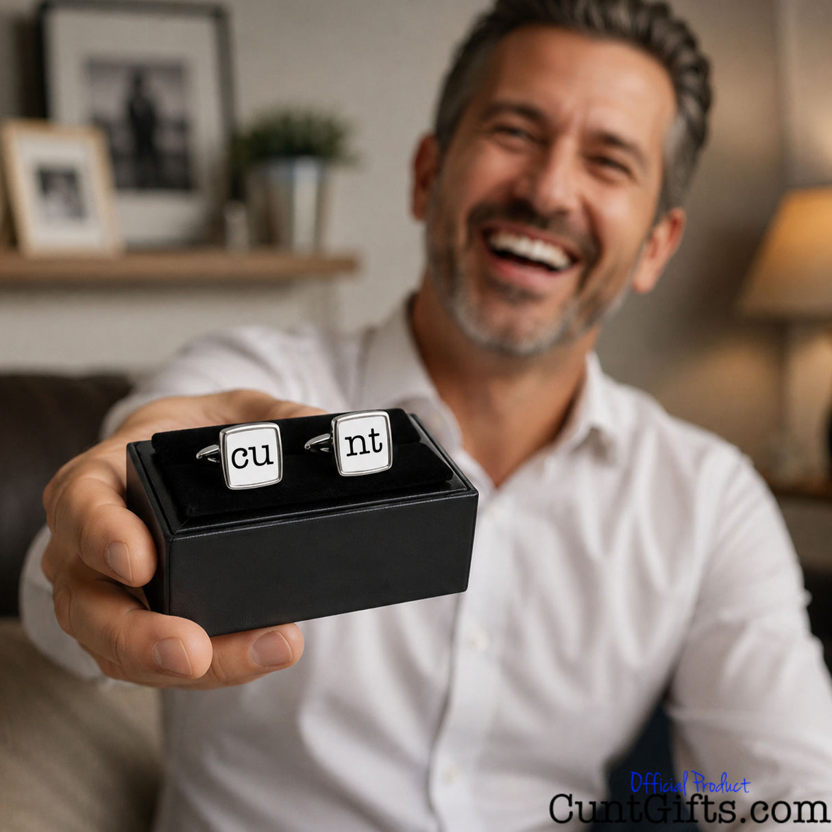 Cunt Cufflinks - CU and NT design held by smiling man with stubble in white shirt.