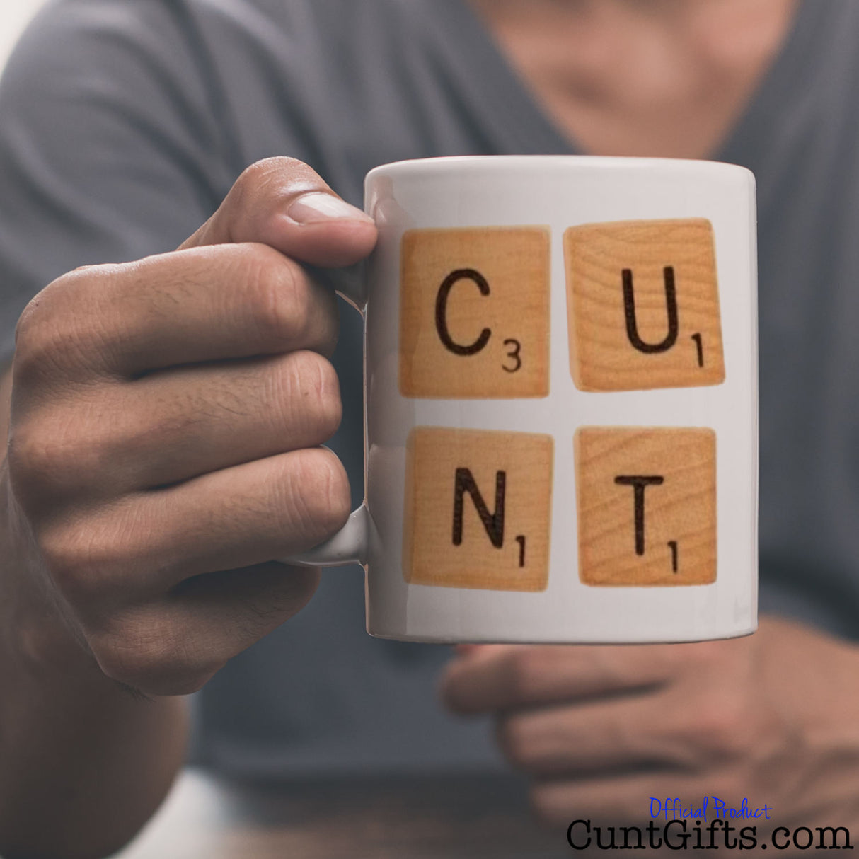Scrabble Cunt Mug held by man in grey t-shirt