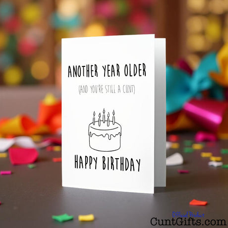 Another year older and you're still a cunt Birthday card on a colourful background