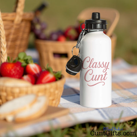White water bottle with 'Classy Cunt' text on a picnic setting