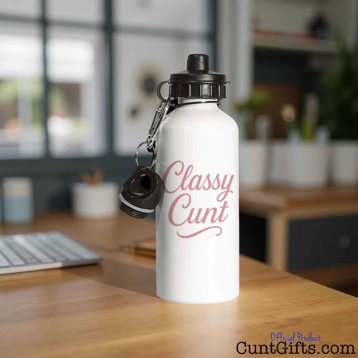 White water bottle with 'Classy Cunt' design on a desk at a workplace by a laptop computer.