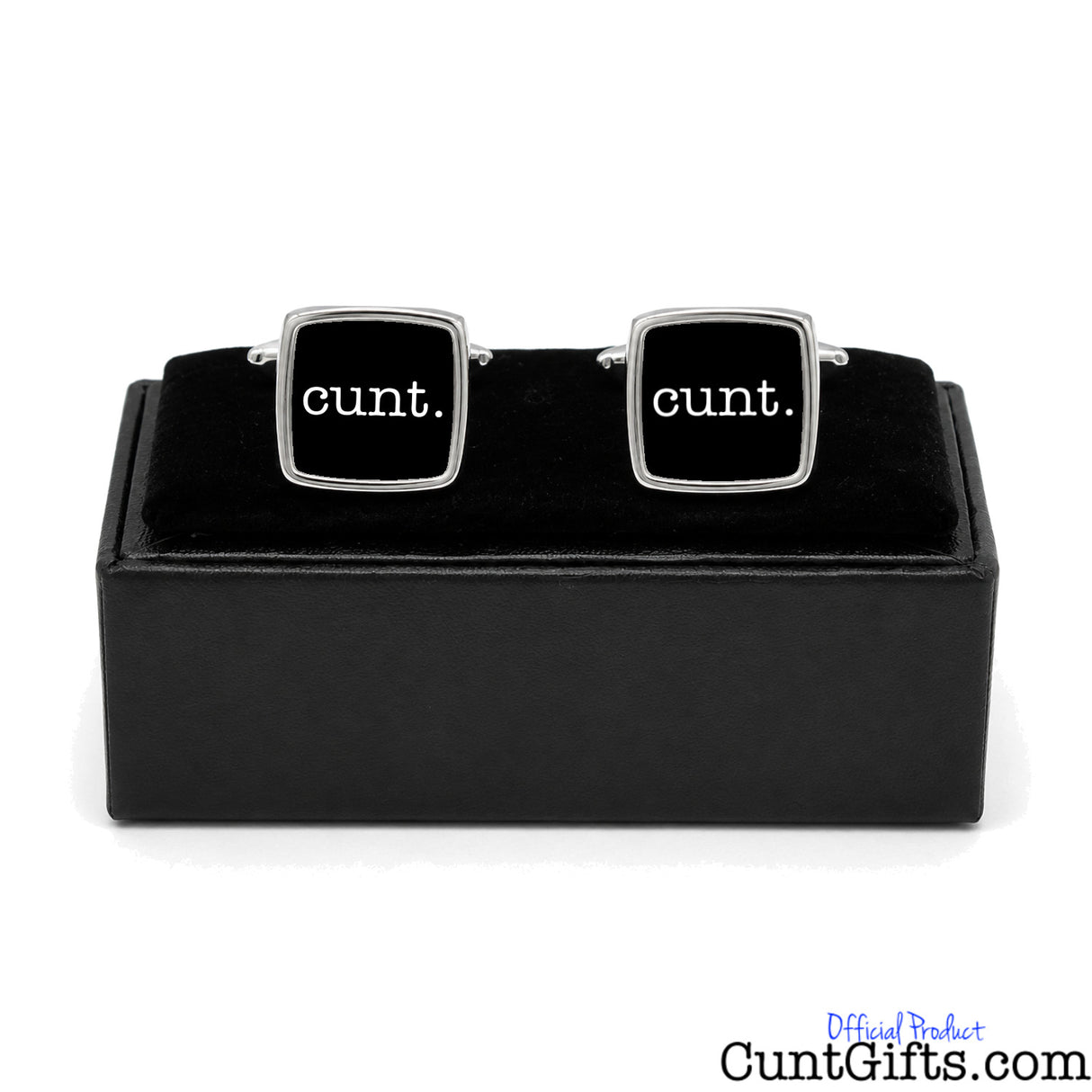 A pair of square silver cufflinks with black faces and the word 'cunt.' printed in white, displayed on a black presentation box against a white background.