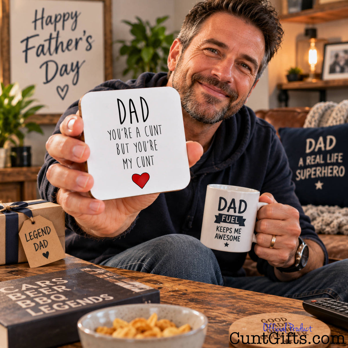 Dad You're a Cunt But You're My Cunt - Drink coaster hled by dad on Father's Day in lounge by coffee table and sofa.