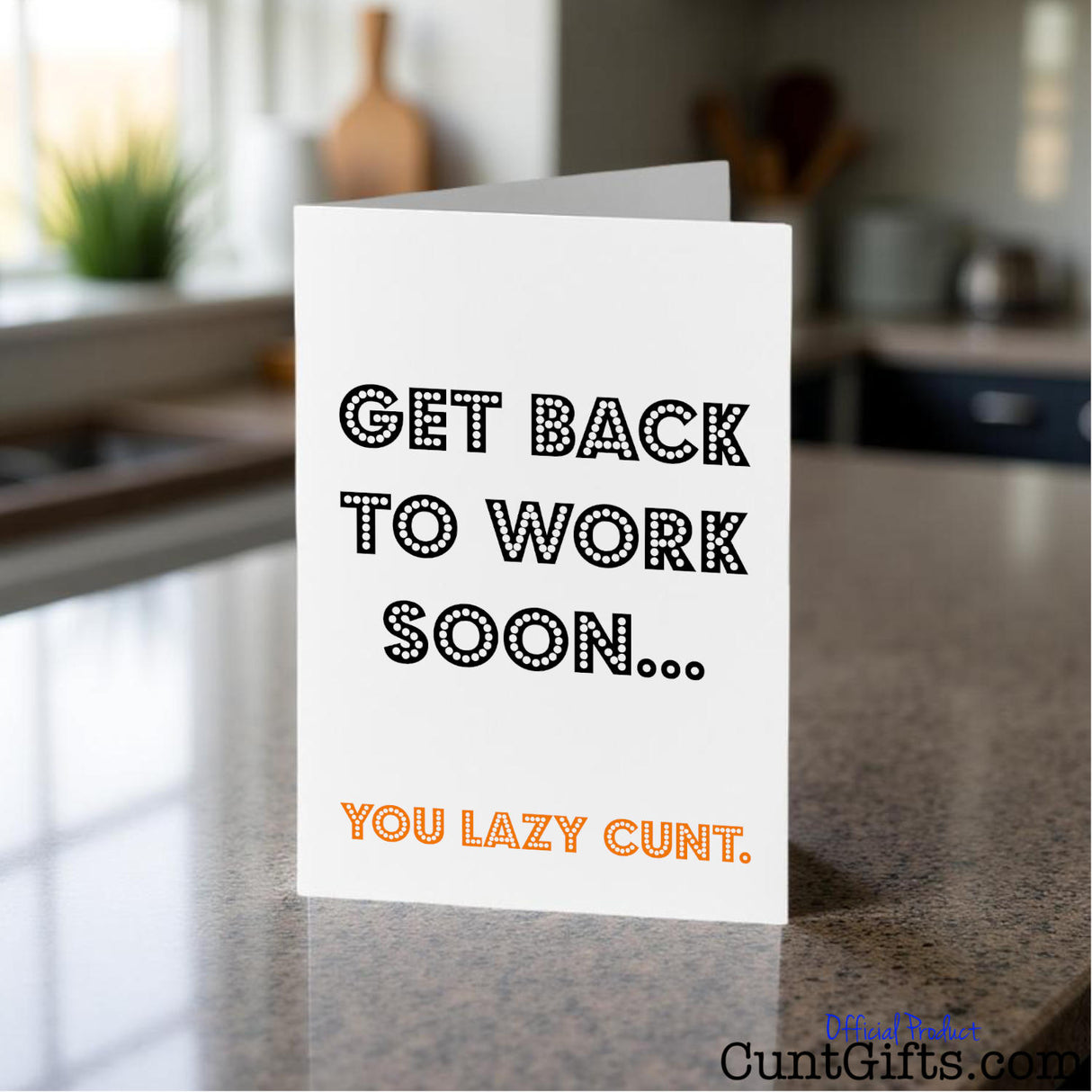 Card with text 'Get back to work soon... you lazy cunt.' on a kitchen counter.