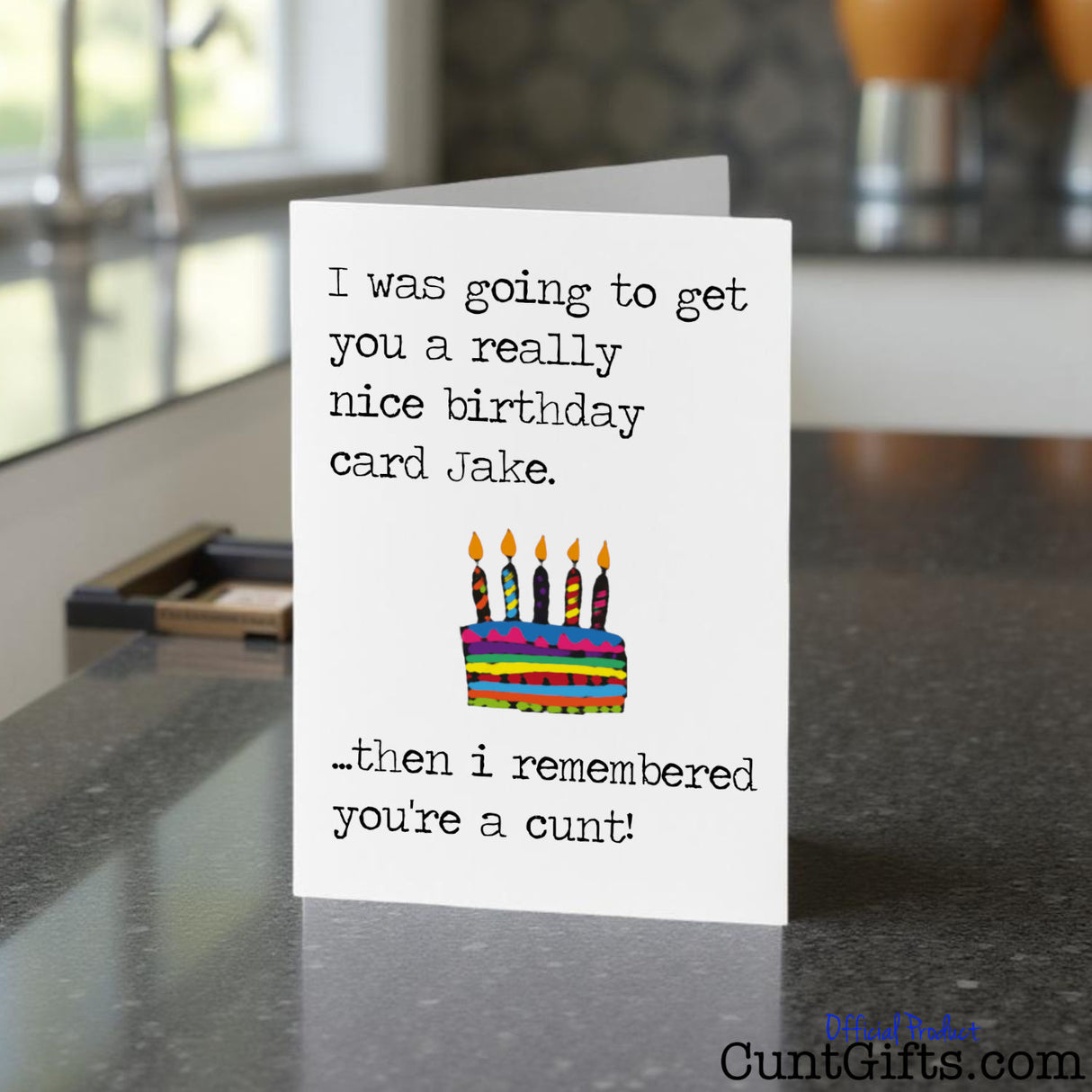 I remembered you're a cunt birthday card with humorous message and birthday cake illustration on a kitchen counter.