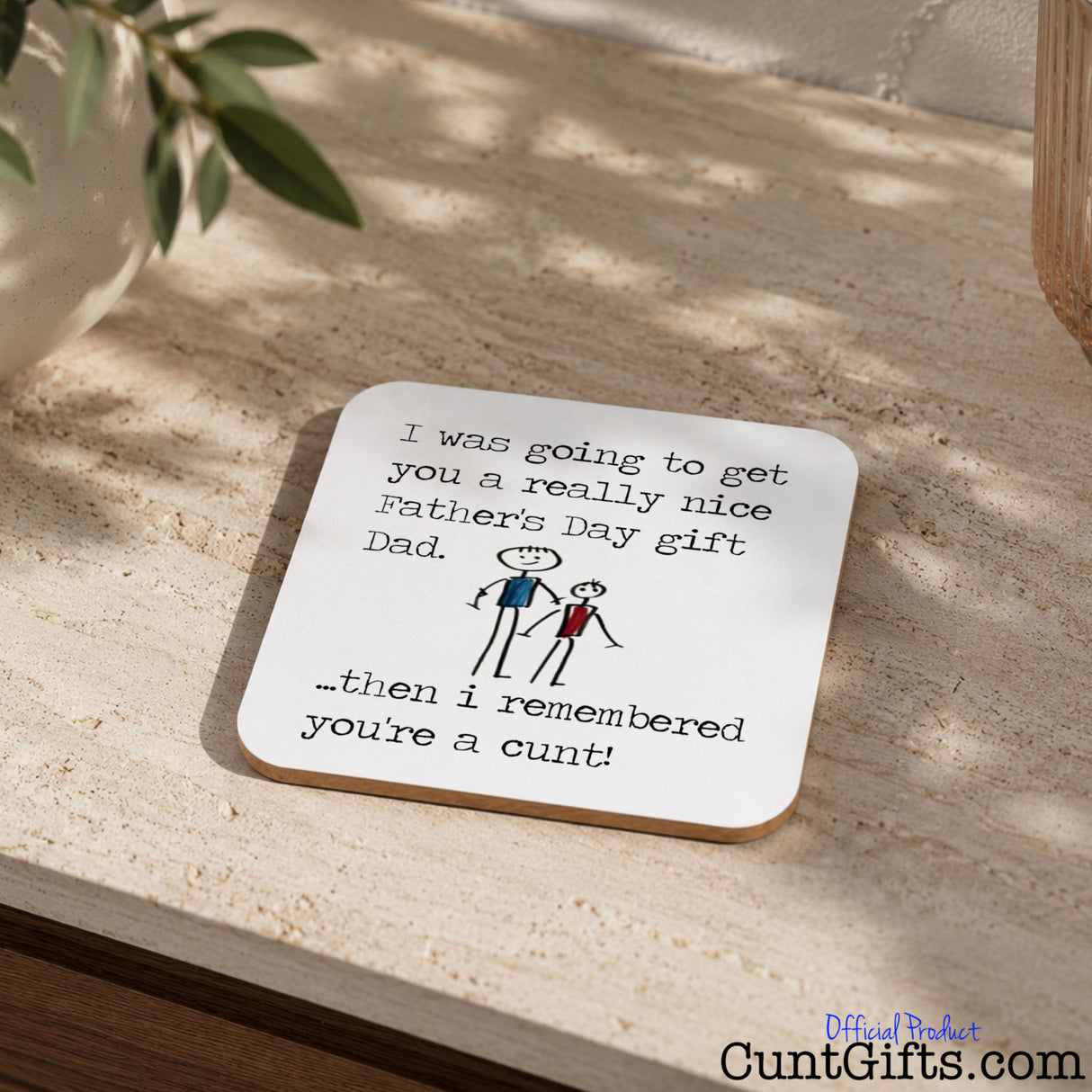 I remembered you're a cunt Dad - Father's Day Drink Coaster on stone table next to plant in pot.