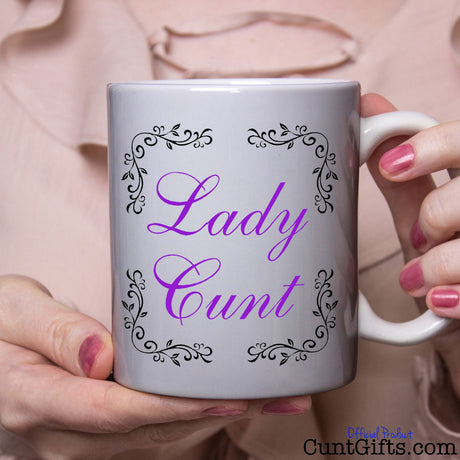 Lady Cunt Mug held by woman in pink blouse