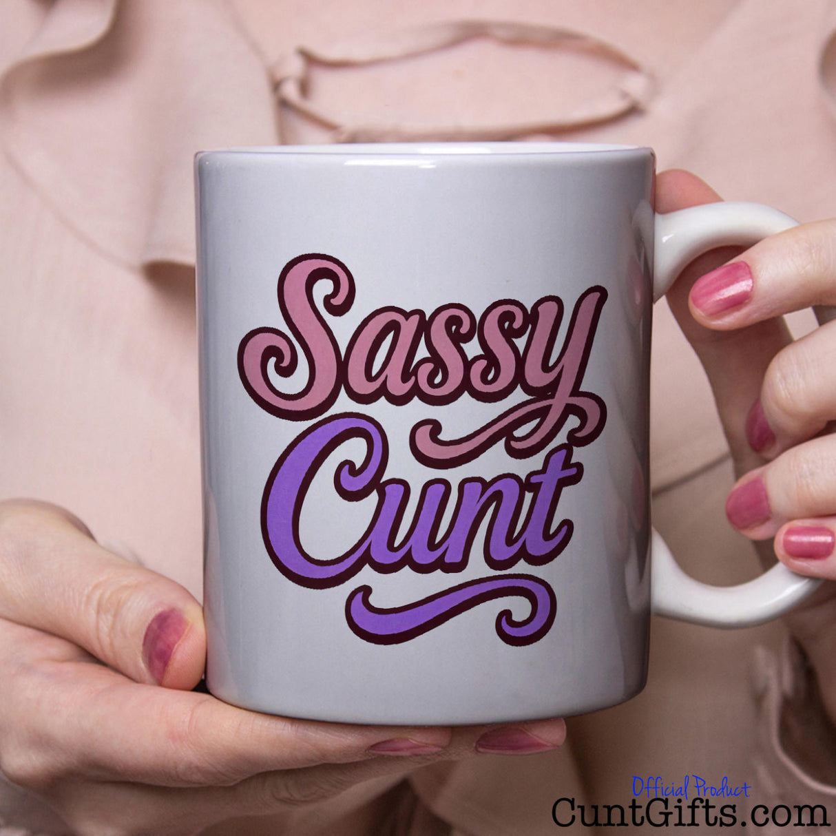 Mug with 'Sassy Cunt' text held by a person with pink blouse and nail polish.