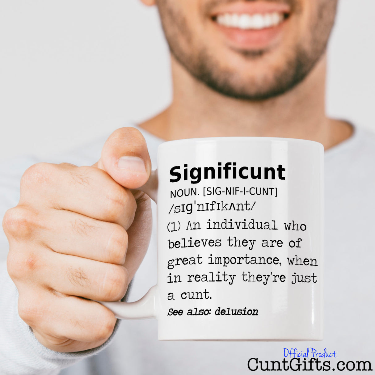 Significunt Mug held out by smiling man with stubble in a white long sleaved t-shirt.