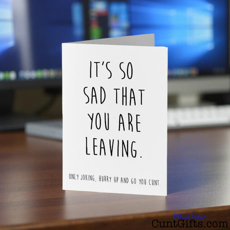 Hurry up and go you cunt leaving card on a desk with a computer in the background