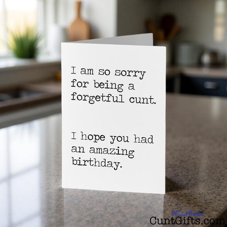 I am a forgetful cunt birthday card  sitting on a kitchen counter with a blurred background