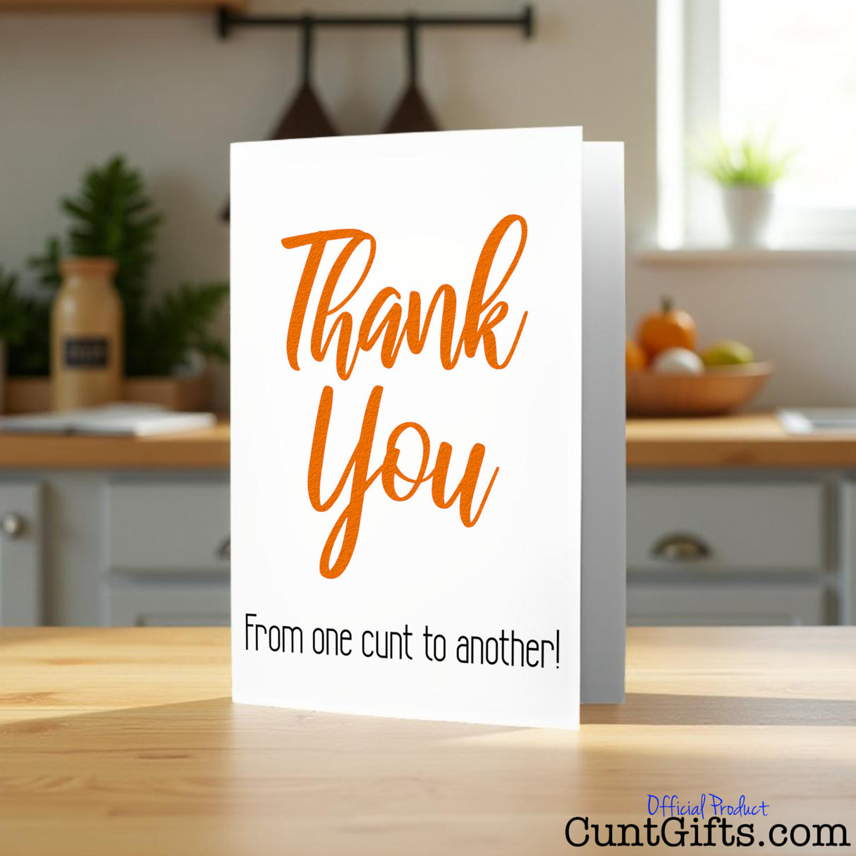 Thank You From One Cunt To Another Greetings Card on wooden counter.