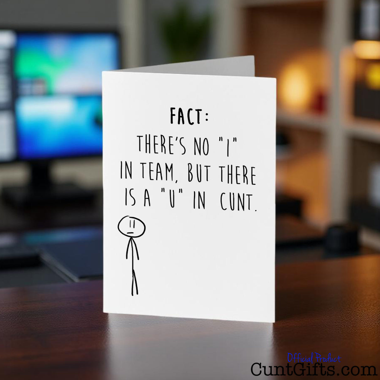There's no "I" in team but there is a "u" in cunt Card on a desk with a blurred office background