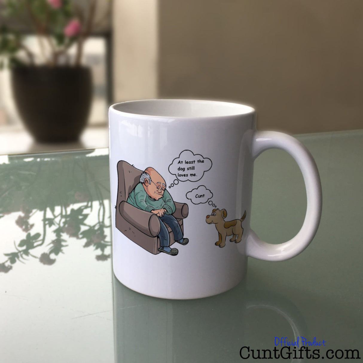 At least the dog still loves me cunt Mug on Glass Table