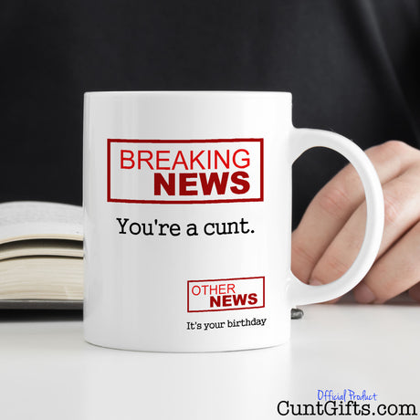Breaking News You're a Cunt - Birthday mug on desk with man reading