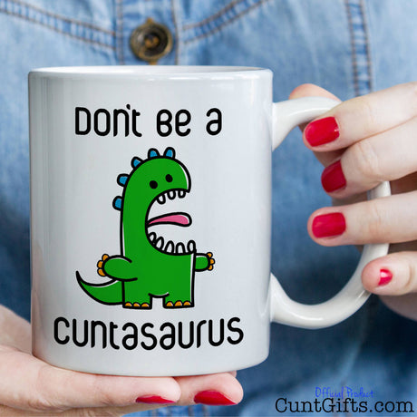 Don't be a Cuntasaurus - Mug held by woman in denim