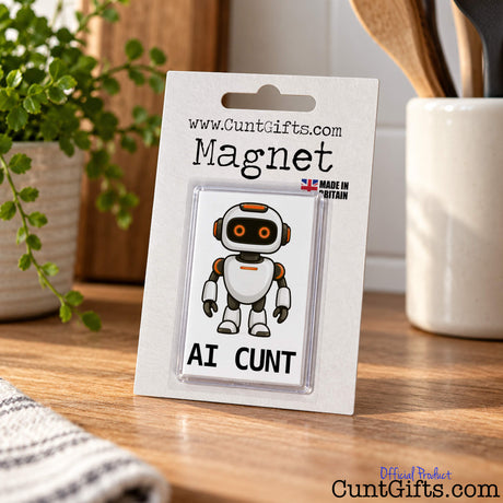 AI Cunt fridge magnet in branded packaging standing upright on a wooden kitchen worktop.
