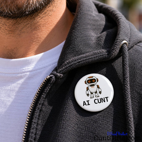 Close-up of a white AI Cunt pin badge featuring a cartoon robot attached to a black jacket.