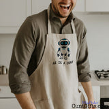 Man wearing a funny AI Is a Cunt apron featuring a cheeky robot design while standing in a kitchen.