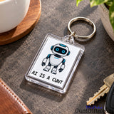Close-up of an AI Is a Cunt acrylic keyring featuring a blue-eyed robot design resting beside a set of keys.