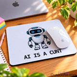 AI Is a Cunt novelty mouse mat featuring a cartoon robot on a wooden desk beside an Apple computer and white mouse.