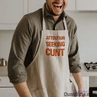 Attention Seeking Cunt - Cooking Apron with man laughing in kitchen