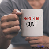 Brentford Cunt Mug held by man in grey v-neck tee