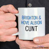 Brighton & Hove Albion Cunt Mug held by man in black shirt