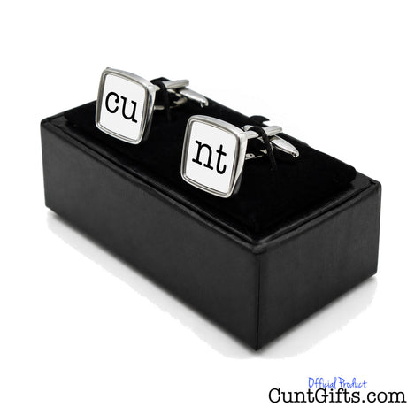 Cunt Cufflinks - CU and NT white design in presentation gift box at angle. 