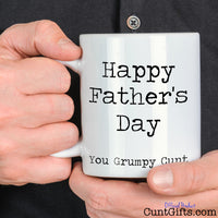Happy Father's Day You Grumpy Cunt - Mug held by man in black shirt