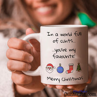 In A World Full Of Cunts You're My Favourite - Christmas Mug held by smiling woman