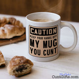 Keep Your Hands Off My Mug You Cunt - Mug with coffee and croissants