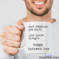 Most stepdads are cunts - Fathers Day Mug held out by man with beard