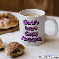 World's Least Cunty Stepmum - Mug with coffee and pastries