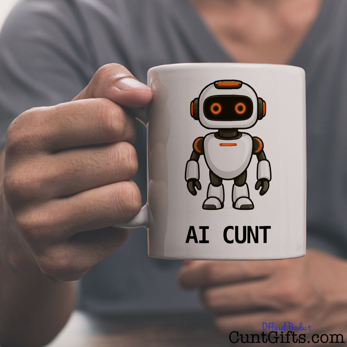 Person holding an AI Cunt novelty mug featuring an orange-eyed cartoon robot and bold black lettering.