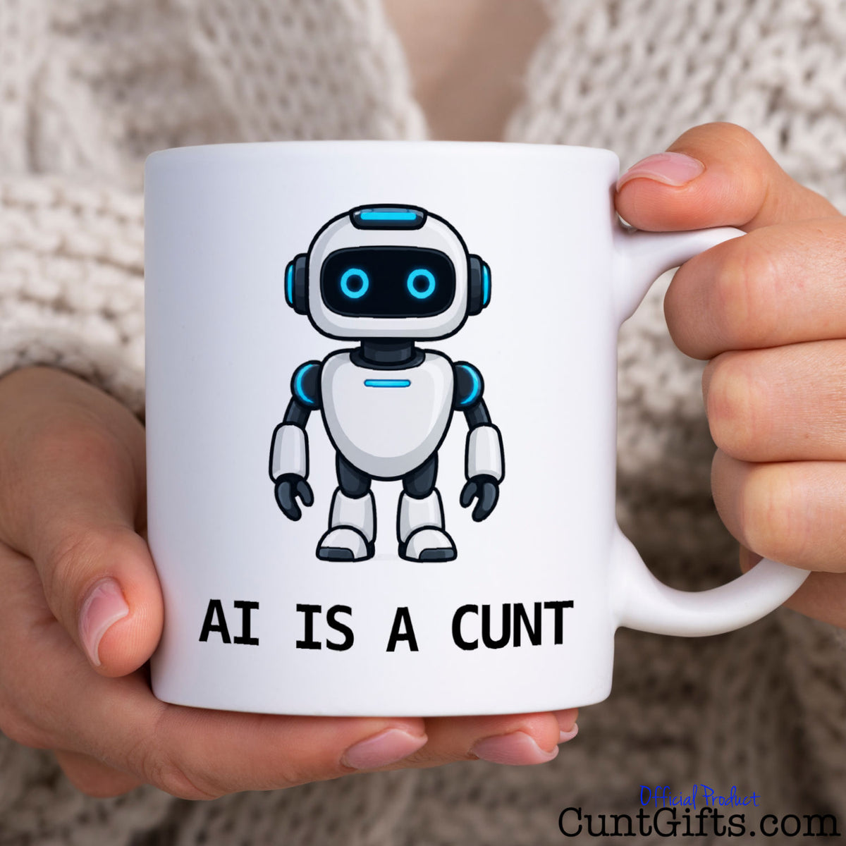 Person holding a funny AI Is a Cunt coffee mug featuring a blue-eyed cartoon robot and rude slogan.
