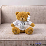 ANY Years of Being a Cunt personalised plush teddy bear with black writing sitting on natural sofa.