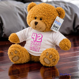 ANY Years of Being a Cunt - personalised birthday teddy bear with pink writing on wooden floor in bedroom.