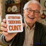 Attention Seeking Cunt - Drink Coaster held by older man with glasses smiling.
