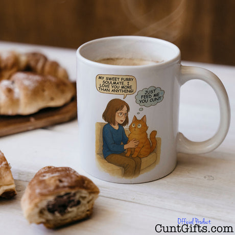 Cat - Just Feed Me You Cunt - Cunt Mug on table with pastries