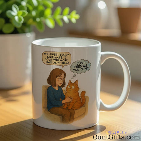 Cat - Just Feed Me You Cunt - Cunt Mug on table by plant
