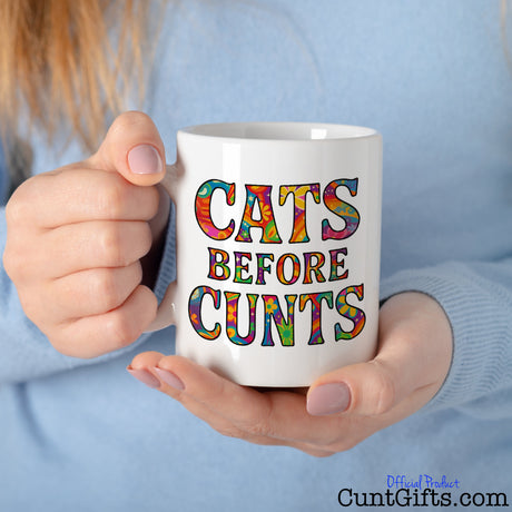 Cats Before Cunts Mug - held by woman in blue jumper