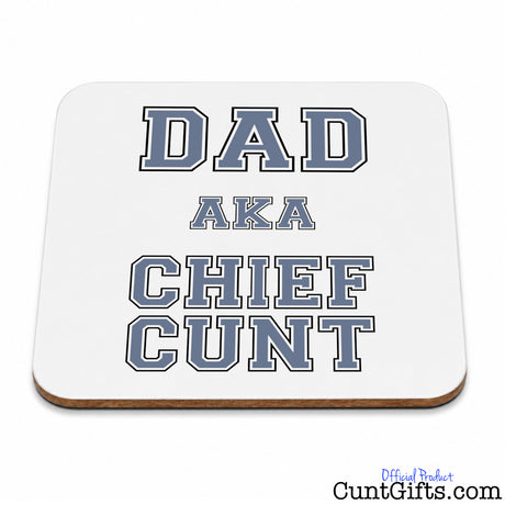 A square white coaster with rounded corners and a light brown wood edge, featuring the text 'DAD AKA CHIEF CUNT' in a blue and grey varsity-style font. 