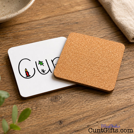 Christmas Cunt Coaster showing both sides on wooden table
