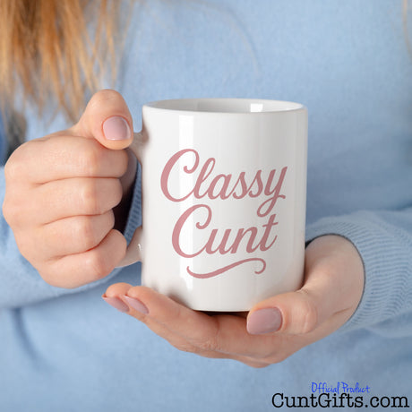 Classy Cunt mug held by woman in a blue sweater