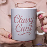 Classy Cunt mug held by woman in pink blouse