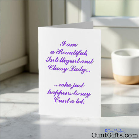 Classy Lady Who Says Cunt Card on a white surface with a blurred background.